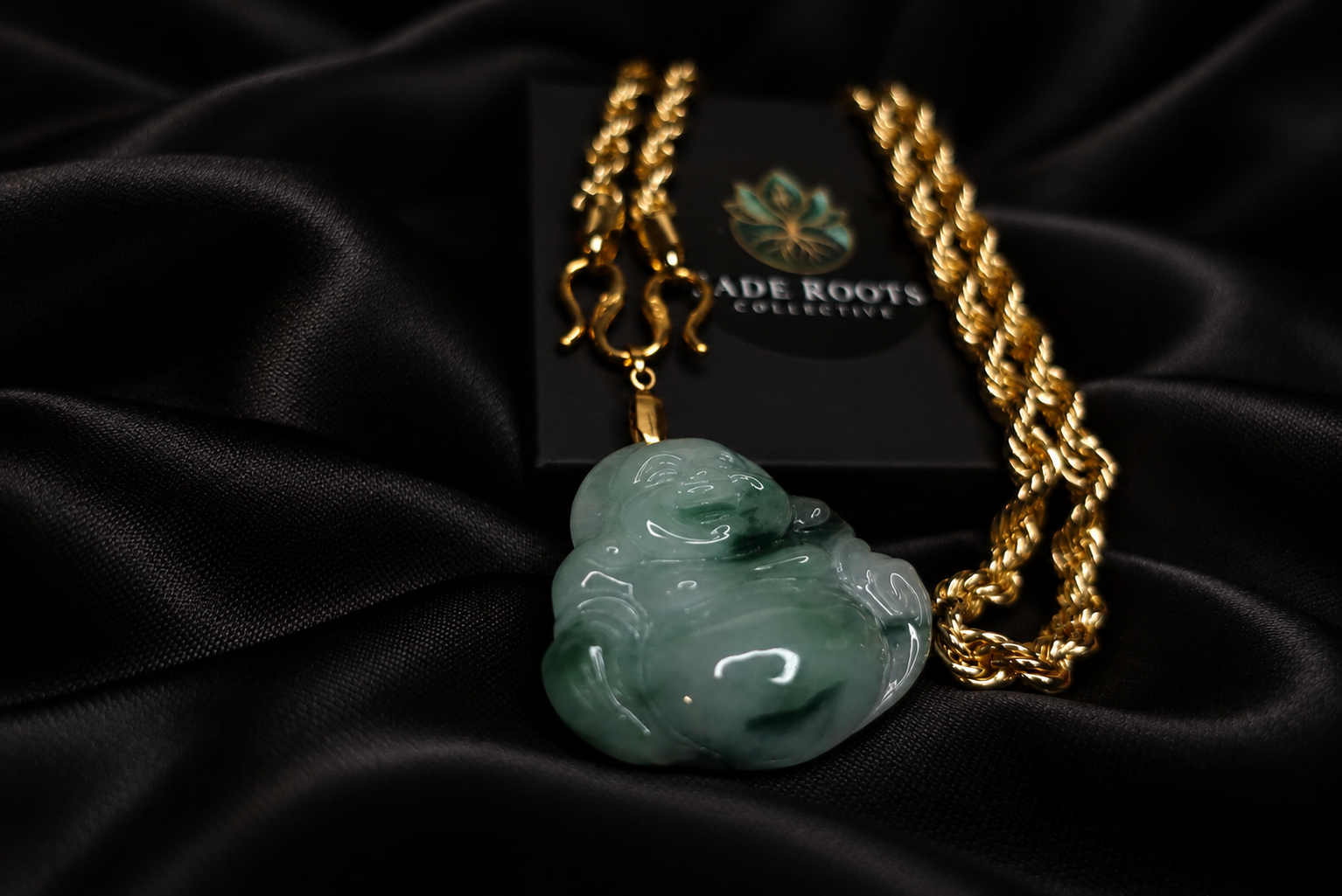 Green jadeite Buddha pendant with gold chain on black silk