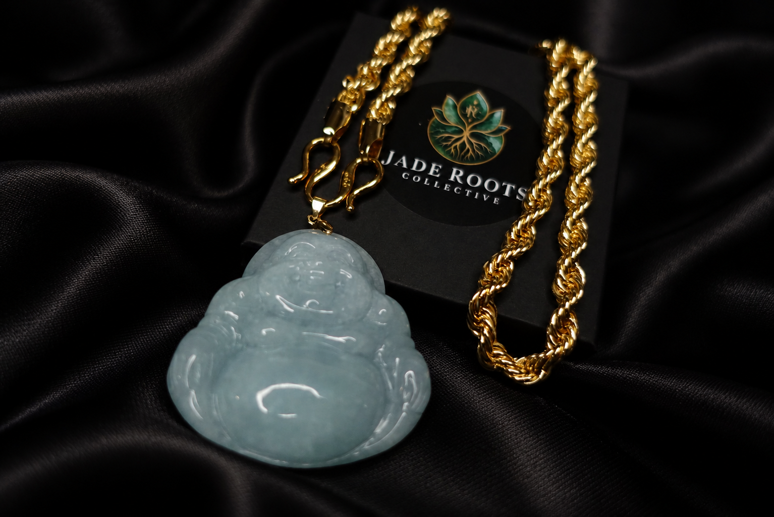 Pale blue jadeite Buddha pendant with gold chain on black silk